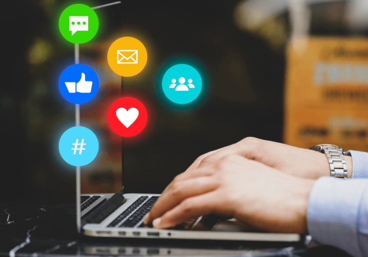 An image showing social icons popping out of a laptop