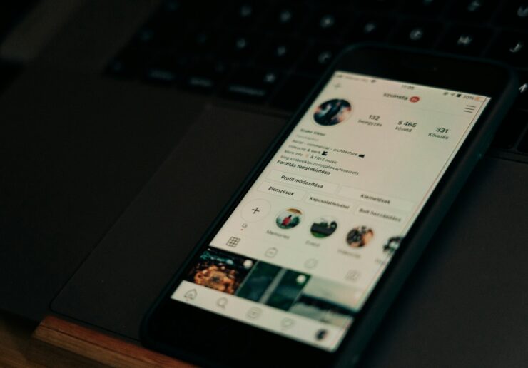 black android smartphone on black laptop computer